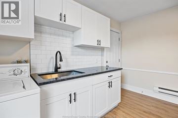 Windsor apartment for rent - A kitchen with white cabinets and a black countertop.