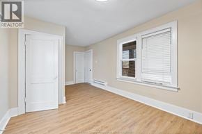 Windsor apartment for rent - A room with a white door, a window with blinds, and wooden flooring.