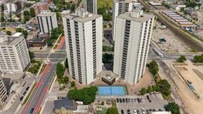 London East (East K) condo for rent - A view of a city with tall buildings, a pool, and a parking lot.