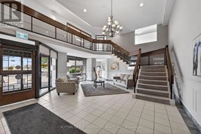 London East (East K) condo for rent - A spacious foyer with a staircase, chairs, and a rug.