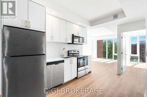 Ottawa condo for rent - A modern kitchen with a refrigerator, oven, and microwave.