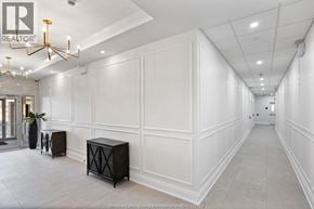 Lasalle condo for rent - A hallway with white walls and a chandelier.