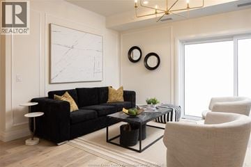 Lasalle condo for rent - A living room with a black couch and a white wall.