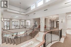 Toronto condo for rent - A large, well-lit, and spacious interior of a building with a curved staircase.