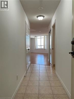 Toronto condo for rent - A long hallway with a door on the right.