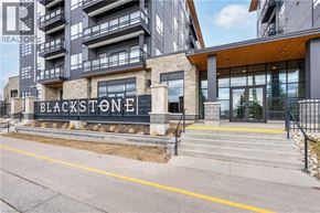 Waterloo condo for rent - The front of a building named Blackstone with a sign in front of it.