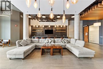 Waterloo condo for rent - A modern living room with a large sectional sofa and a coffee table.