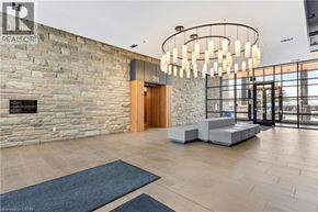 Waterloo condo for rent - A modern interior with a stone wall and a wooden door.
