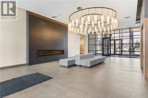 Waterloo condo for rent - A modern living room with a fireplace and a large chandelier.