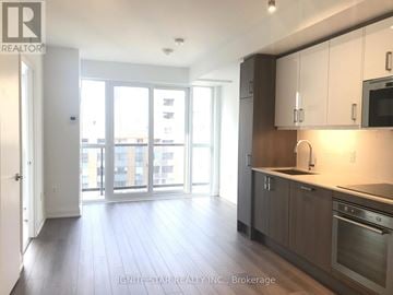 Toronto (Church-Yonge Corridor) condo for rent - A kitchen with white cabinets and a stainless steel oven.