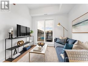 Toronto (Oakridge) townhouse for rent - A living room with a television, a sofa, and a coffee table.