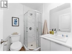 Toronto (Oakridge) townhouse for rent - A white bathroom with a toilet, sink, and shower.
