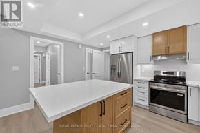 Innisfil (Alcona) apartment for rent - A modern kitchen with a white countertop and stainless steel appliances.