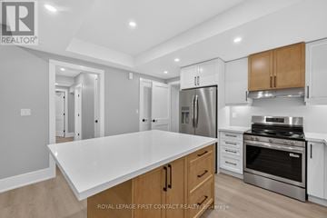 Innisfil (Alcona) apartment for rent - A modern kitchen with a white countertop and stainless steel appliances.