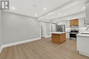 Innisfil (Alcona) apartment for rent - A well-lit kitchen with wooden floors and white walls.