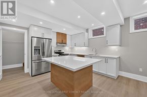 Innisfil (Alcona) apartment for rent - A modern kitchen with a wooden island and stainless steel appliances.