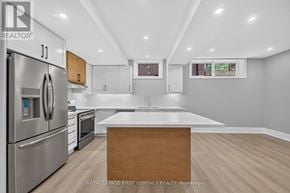Innisfil (Alcona) apartment for rent - A modern kitchen with a wooden island in the middle.