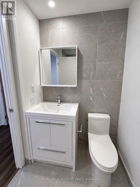 Vaughan (Vaughan Corporate Centre) condo for rent - A white toilet sits next to a sink in a bathroom.