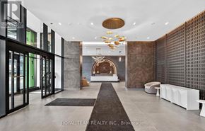 Vaughan (Vellore Village) condo for rent - A modern and luxurious hallway with a chandelier and a fireplace.