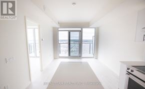 Vaughan (Vellore Village) condo for rent - A spacious, empty room with a large window overlooking a beach.