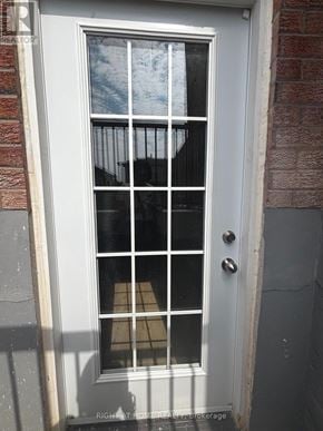 Oakville (Wc Wedgewood Creek) apartment for rent - A white door with a glass window and a metal handle.