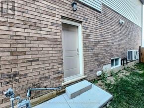 Hamilton apartment for rent - A brick house with a white door and a concrete step.