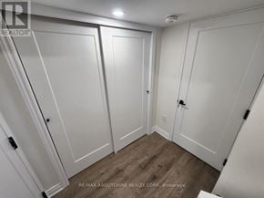 Hamilton apartment for rent - A white closet with a wooden floor and a white door.