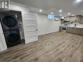 Hamilton apartment for rent - A kitchen with a white door and a black dishwasher.