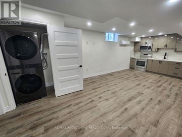 Hamilton apartment for rent - A kitchen with a white door and a black dishwasher.