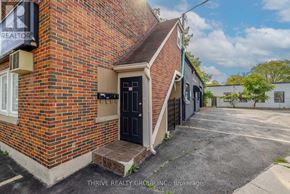 London East (East K) apartment for rent - A brick building with a black door and a sign that says REALTOR.