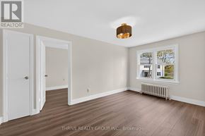 London East (East K) apartment for rent - A room with a window showing a tree and a building outside.