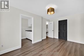 London East (East K) apartment for rent - A room with a black door and a white cabinet.