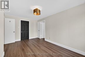 London East (East K) apartment for rent - A room with a black door and a white door with a wooden floor.