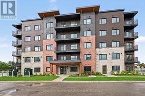 Arnprior condo for rent - A large apartment building with a red door in the front.