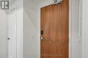 Arnprior condo for rent - A brown door with a silver handle and lock.