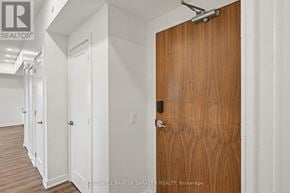 Arnprior condo for rent - A brown door is in a white hallway.