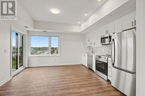 Arnprior condo for rent - A modern kitchen with white appliances and wooden floors.