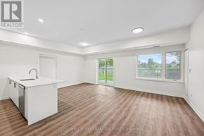 Arnprior condo for rent - A spacious room with a kitchenette and sliding glass doors leading to a patio.