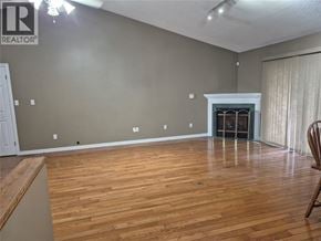 Sarnia apartment for rent - A room with wooden flooring and a fireplace.