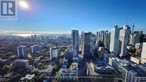 Toronto (Moss Park) condo for rent - A cityscape with a clear sky and buildings of various heights.
