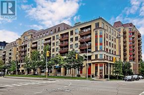 Toronto (Bayview Village) condo for rent - A large apartment building with a red awning and balconies.