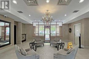 Toronto (Bayview Village) condo for rent - A spacious living room with a chandelier, grey couches, and a coffee table.