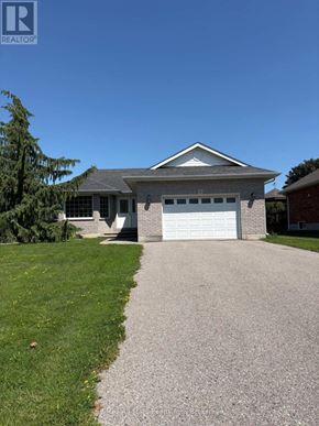 Kawartha Lakes (Lindsay) apartment for rent - A house with a garage and a driveway in front.