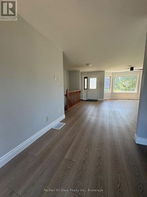 Kawartha Lakes (Lindsay) apartment for rent - A room with wooden flooring and white walls.
