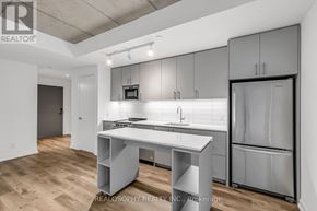 Toronto (South Riverdale) condo for rent - A modern kitchen with a white countertop and grey cabinets.