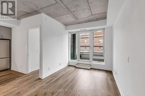 Toronto (South Riverdale) condo for rent - A room with a window showing a view of a building outside.
