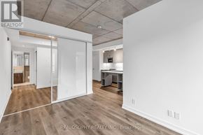 Toronto (South Riverdale) condo for rent - A spacious office room with a desk and a whiteboard.