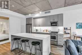 Toronto (South Riverdale) condo for rent - A modern kitchen with a white countertop and stainless steel appliances.