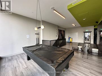 Toronto (South Riverdale) condo for rent - A modern bedroom with a large bed and a green accent wall.