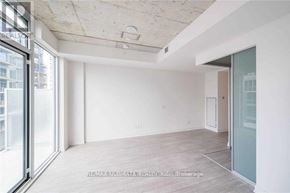 Toronto (South Riverdale) condo for rent - A spacious room with a sliding glass door leading to a balcony.